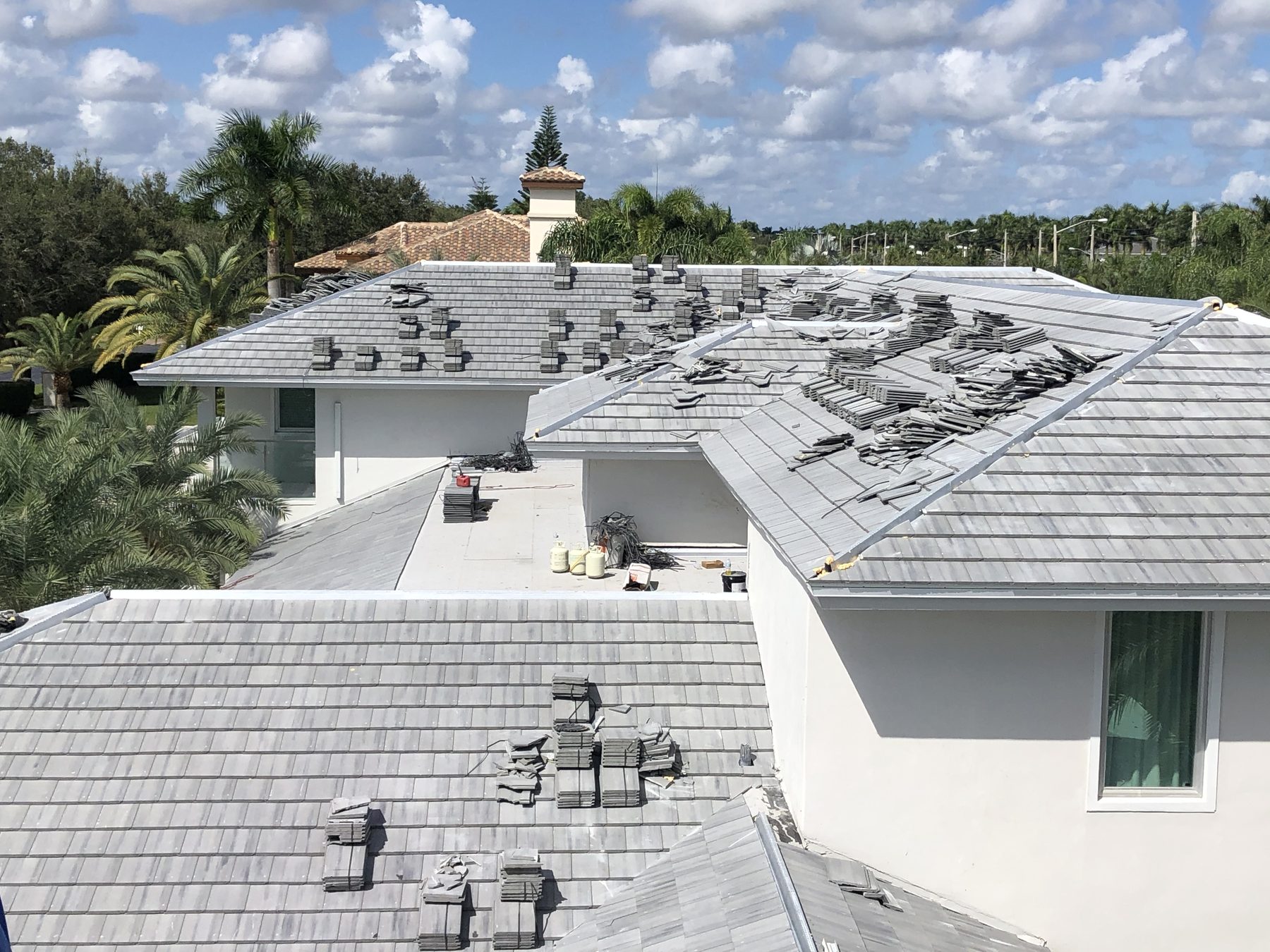 Saxony 900 Slate concrete roof tile installation in progress on a large South Florida home.